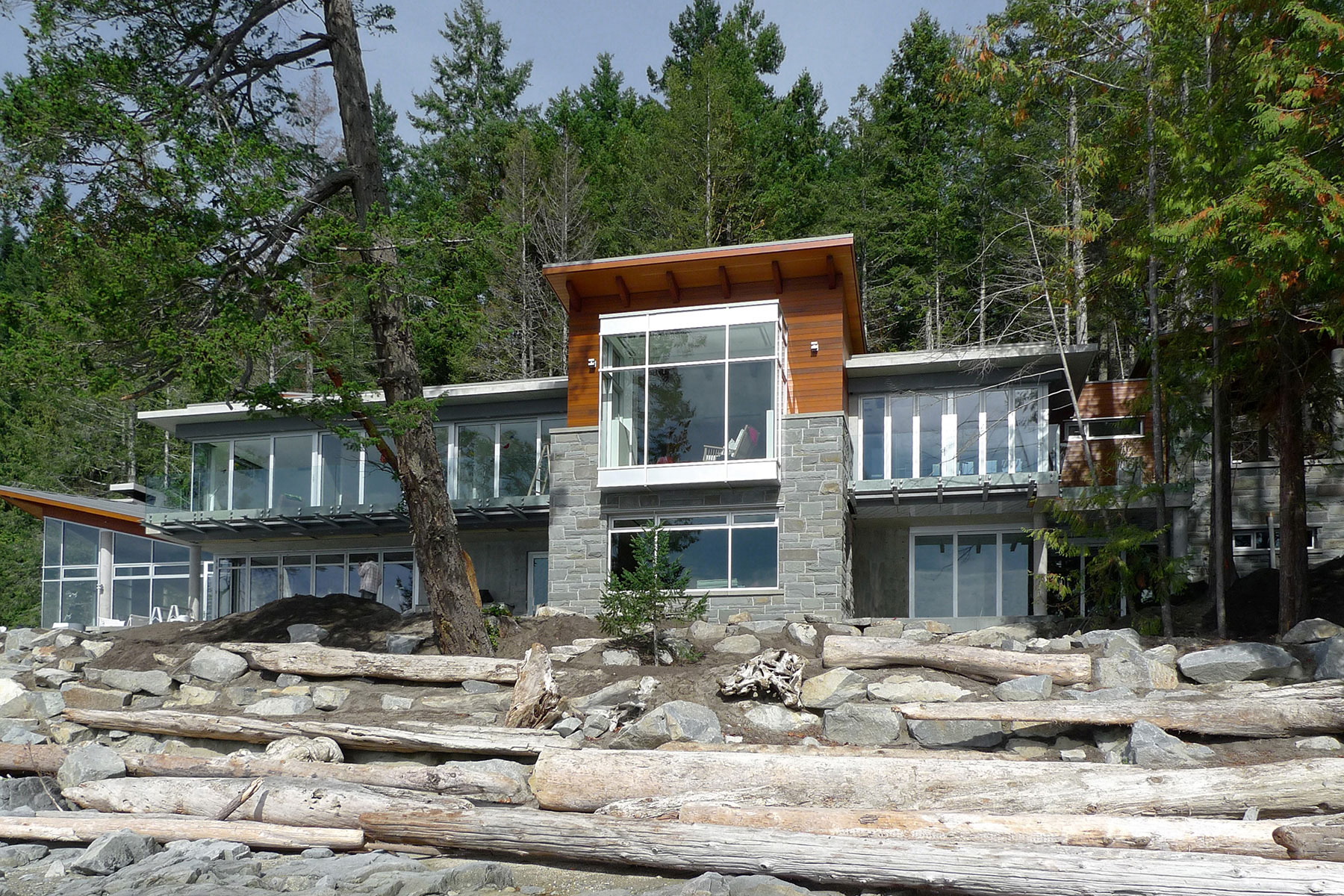 The house seen from the driftwood beach below