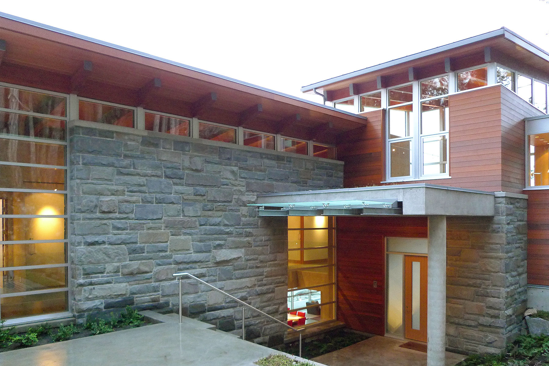 Stone-walled entry court with concrete canopy
